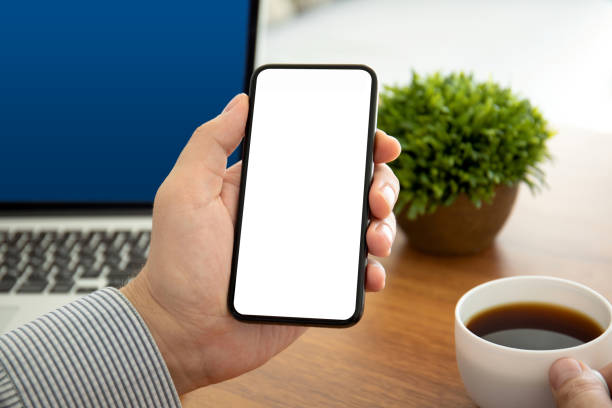 istock male hands holding phone with isolated screen in the office 1149270995