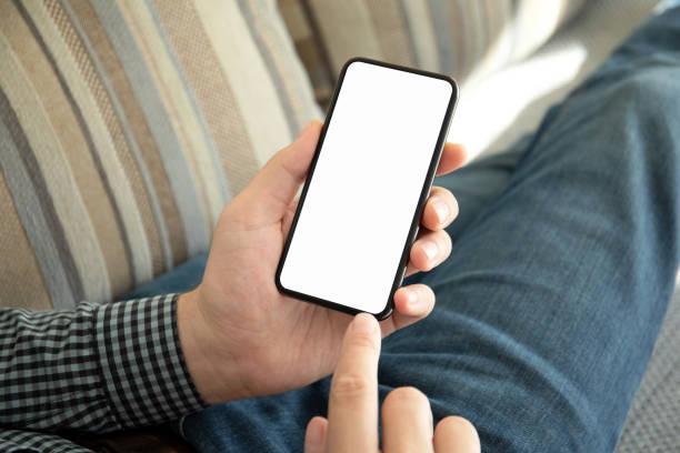 istock male hands holding phone with isolated screen on the sofa 1149271057