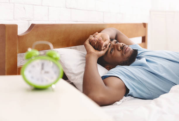 istock Black man in bed suffering from insomnia and sleep disorder 1149271139