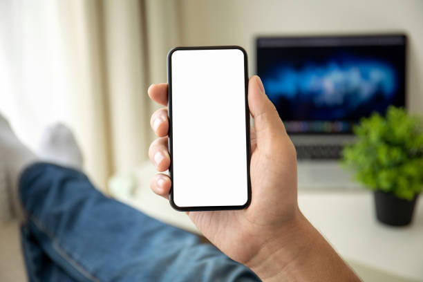 istock man hands holding phone with isolated screen in the room 1149272201