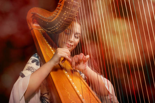 Professional female harpist during performance stock photo