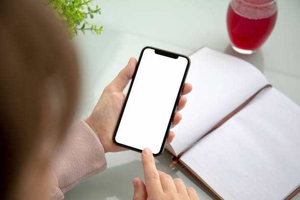 istock woman hands holding touch phone with isolated screen in office 1149272417