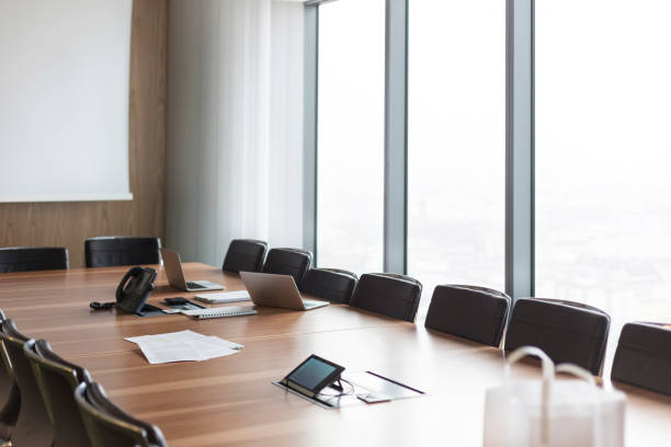 istock Documents with laptop and telephone on conference table in boardroom at modern office 1149273668