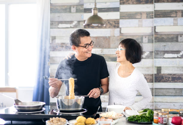 istock Chinese couple cooking at home 1149276782