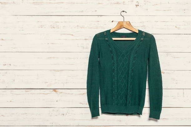 istock knitted sweater on wooden clothes rack 1149280083