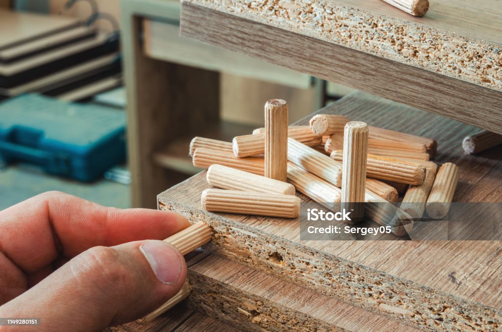 Furniture Fittings Wooden Dowels Fastener Connection On Chipboard  Workpieces Closeup Stock Photo - Download Image Now - iStock