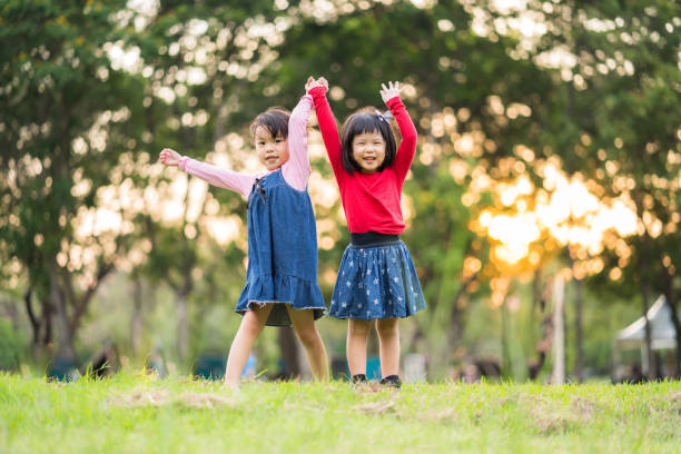 istock A girls are playing together on green grass 1149280212