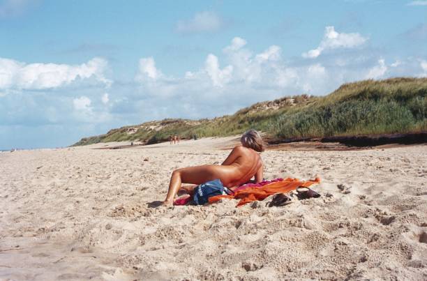 Langeland Island, Denmark, 1983. Vacationers sunbathing on a beach section on the holiday island Langeland.
