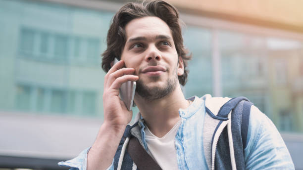 istock Young man with mobile phone in the street 1149280931