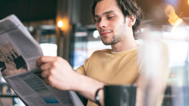 istock Young man reading the newspaper 1149282174