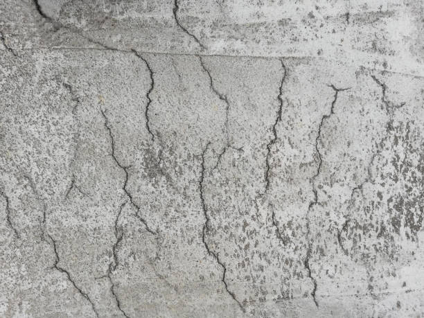 Cracked reinforced concrete on a surface due to shrinkage in the curing process