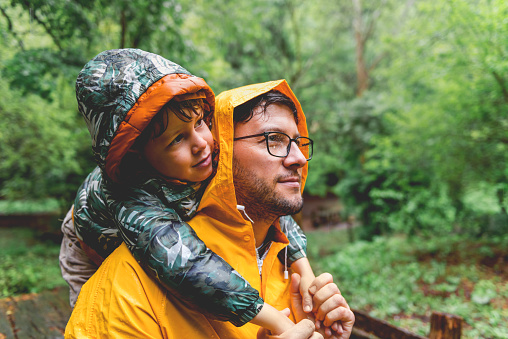 Father and son having fun on rainy day