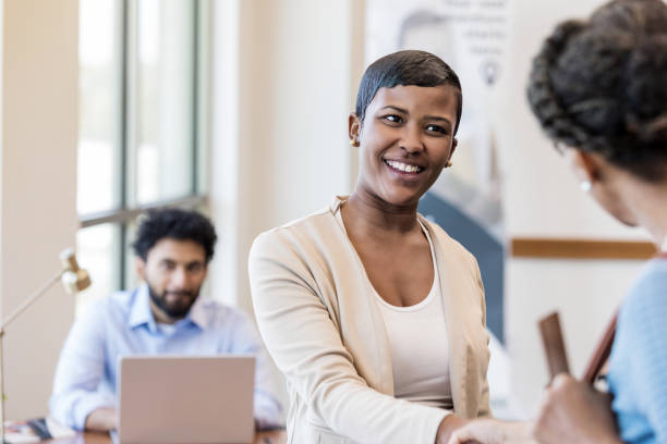 istock Mid adult customer service representative greets new customer 1149285633