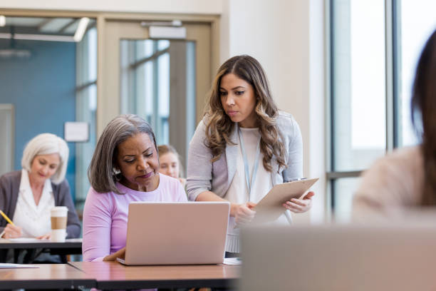 istock Hispanic tutor helps African American student understand 1149286181