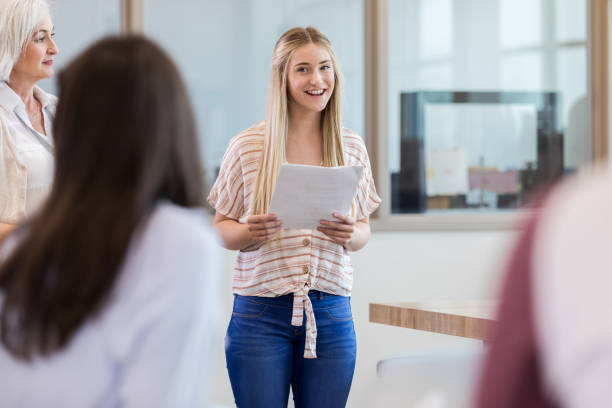 istock Teen girl quizzes classmate during presentation 1149286313