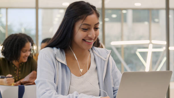 istock Confident Hispanic female college student in library 1149286323