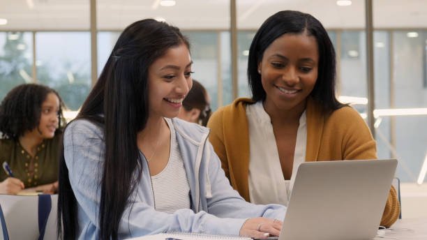istock Cheerful female college student studies with tutor 1149286330