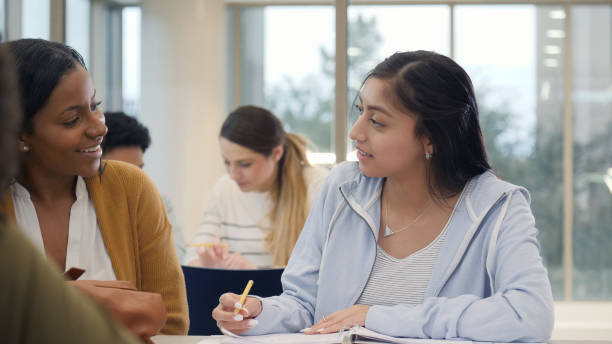 istock Hispanic female college student studies with friend 1149286353