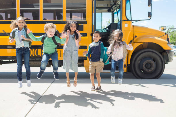 istock Multi-ethnic school children jump in excitement 1149286851