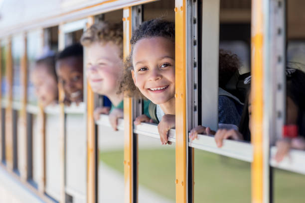 istock Children look out school bus windows 1149286853