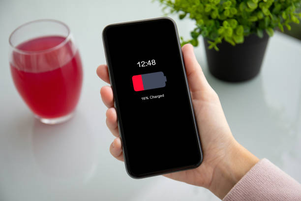 istock female hand holding touch phone with low charged battery 1149287116