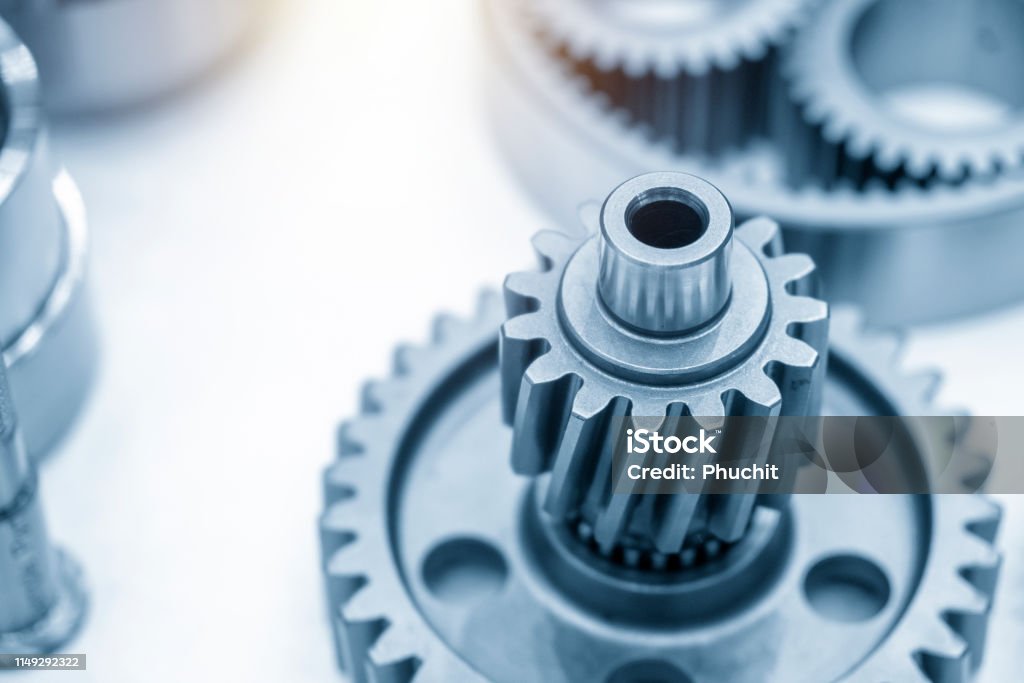 The gear parts of the automotive transmission. The gear parts of the automotive transmission. Mechanical part manufacturing concept. Gear - Mechanism Stock Photo