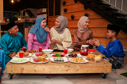 On the morning of Hari Raya Aidilfitri / Eid-Ul-Fitr, a Malay Muslim family get together for a feast to celebrate the auspicious day in Malaysia, after a month of fasting during Ramadan.