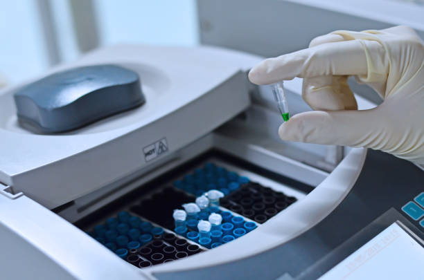 istock Scientist holding PCR tube put into PCR machine 1149293226