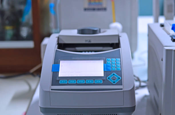 istock Scientist holding PCR tube put into PCR machine 1149293311