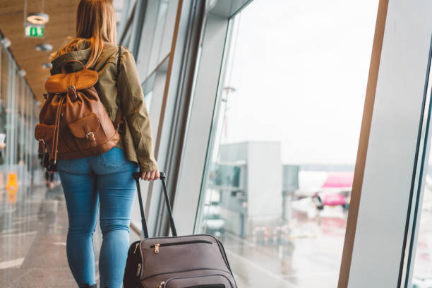 istock Young woman with cabin luggage 1149293666