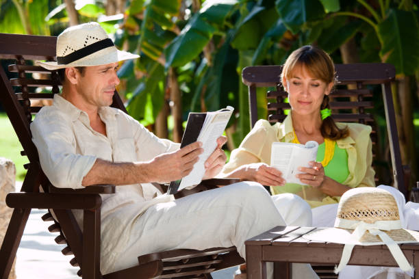 istock couple reading in a tropical park 1149293769