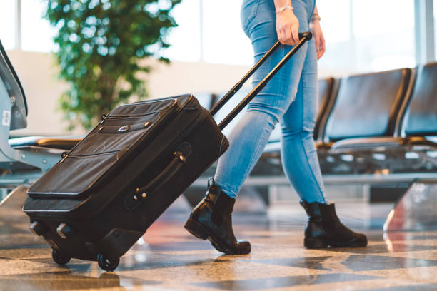 istock Tourist walking and pulling a small wheeled luggage 1149293970