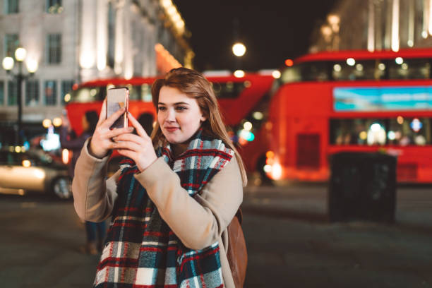 istock Tourist taking a picture in Piccadilly Circus at night 1149295237