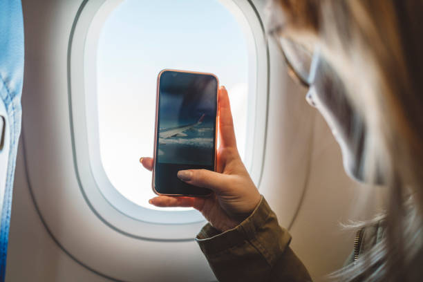 istock Girl taking a picture of a view while flying 1149295910
