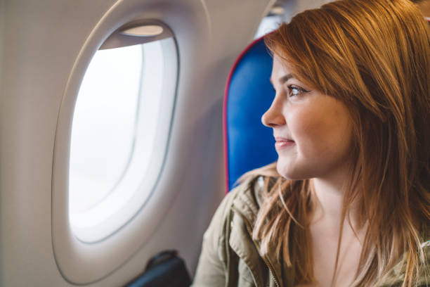 istock Young woman excited about flying on a plane 1149296186