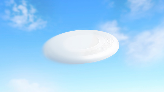 Blank white flying plastic frisbee mockup, motion blur, sky background, 3d rendering. Empty flying disc mock up on blue. Clear round toy moving for game in park. Air disk for print design template.