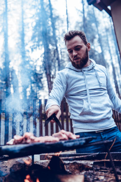 istock Handsome Male Preparing Barbecue Dinner 1149296354