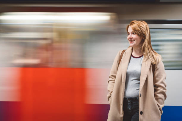 istock Girl smiling in front of a moving underground train 1149296802