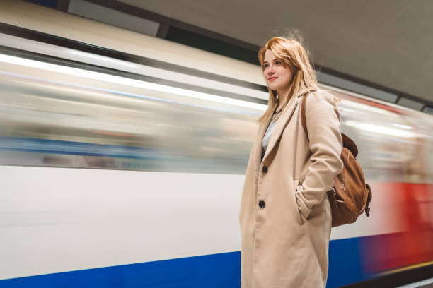 istock Young woman waiting for metro train to stop 1149297407