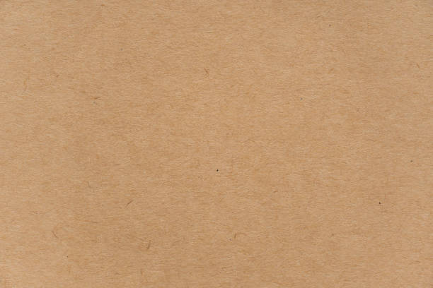 istock Abstract brown recycled paper texture background or backdrop. Empty old cardboard or recycling paperboard for design element. Simple beige grainy surface for journal template presentation. 1149297594
