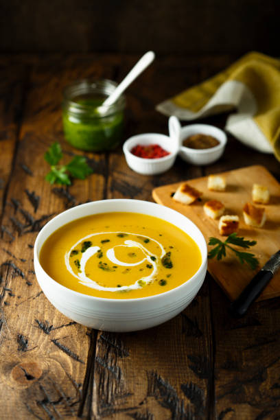 istock Pumpkin soup with pesto sauce 1149297599