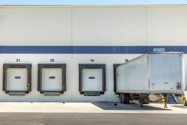 Modern warehouse loading zone and a trailer Modern warehouse loading zone and a trailer loading bay stock pictures, royalty-free photos & images