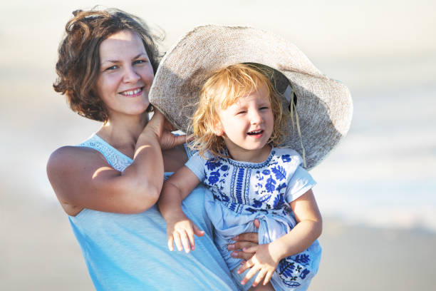 istock Loving mother and daughter at the beach 1149299436