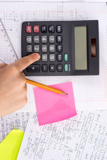 istock Finger on the Calculator Button During Mathematical Lesson. School Concept. 1149299910