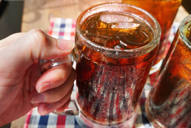 istock Hand hold a glasses of cola with ice. 1149300426