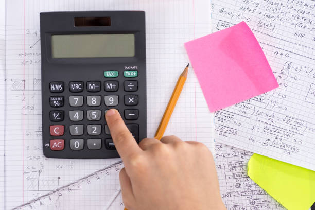 istock Finger on the Calculator Button During Mathematical Lesson. School Concept. 1149300466