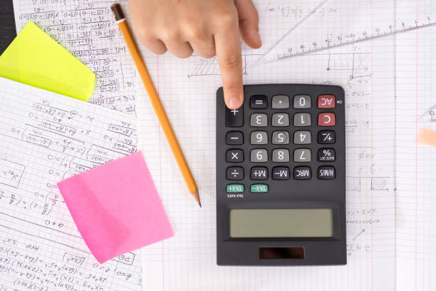 istock Finger on the Calculator Button During Mathematical Lesson. School Concept. 1149300561