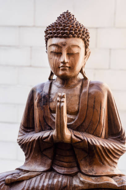 istock Buddha statue with hands in praying position 1149302355