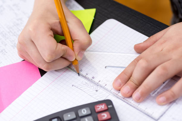 istock Schoolboy Hands with Ruler Drawing on Paper. Mathematics Concept. 1149304870