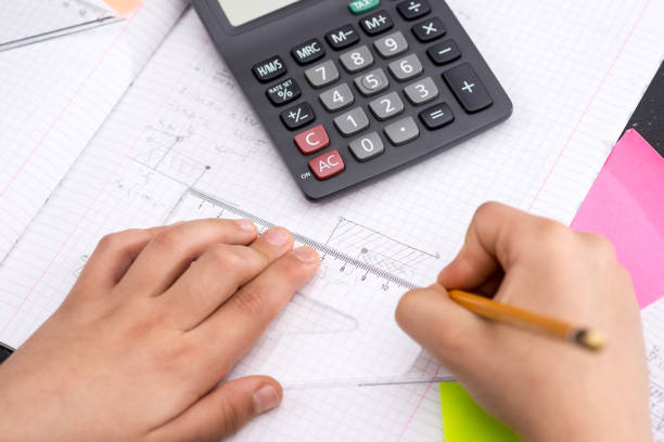 istock Schoolboy Hands with Ruler Drawing on Paper. Mathematics Concept. 1149304907